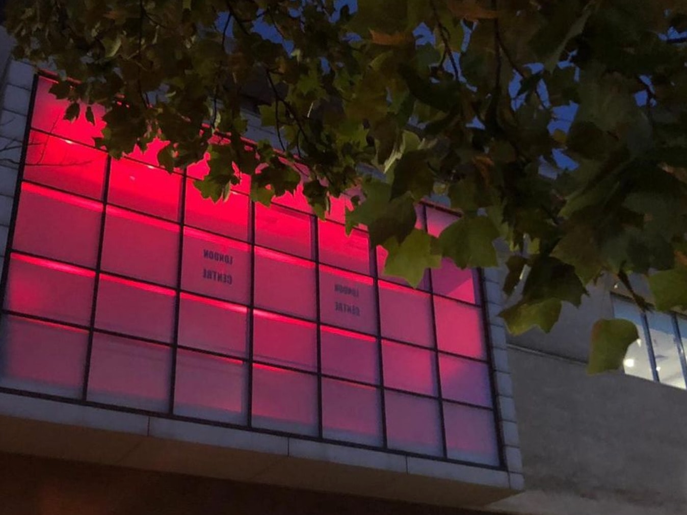 Outside of artsdepot building, lit in pink