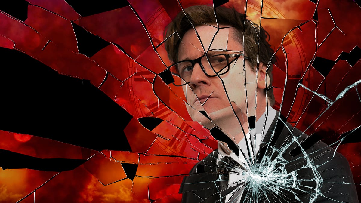 Comedian Ed Byrne is featured on the right hand side of the image, behind an overlay of cracked glass. The background shows a burnt orange sky with a large clock framing the performer's head.