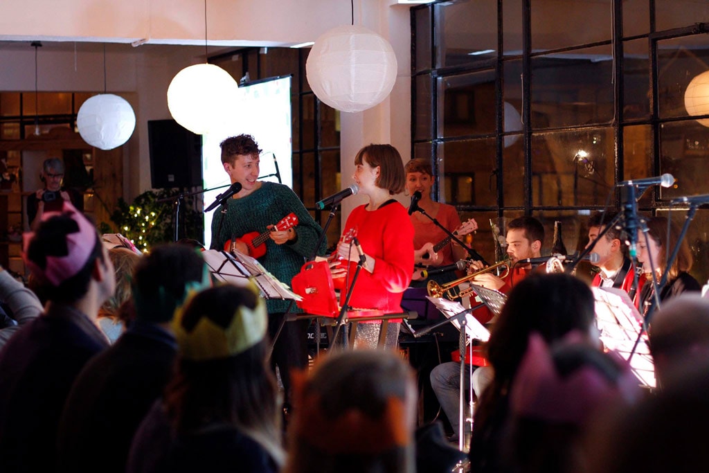 A group of people watching musicians on stage