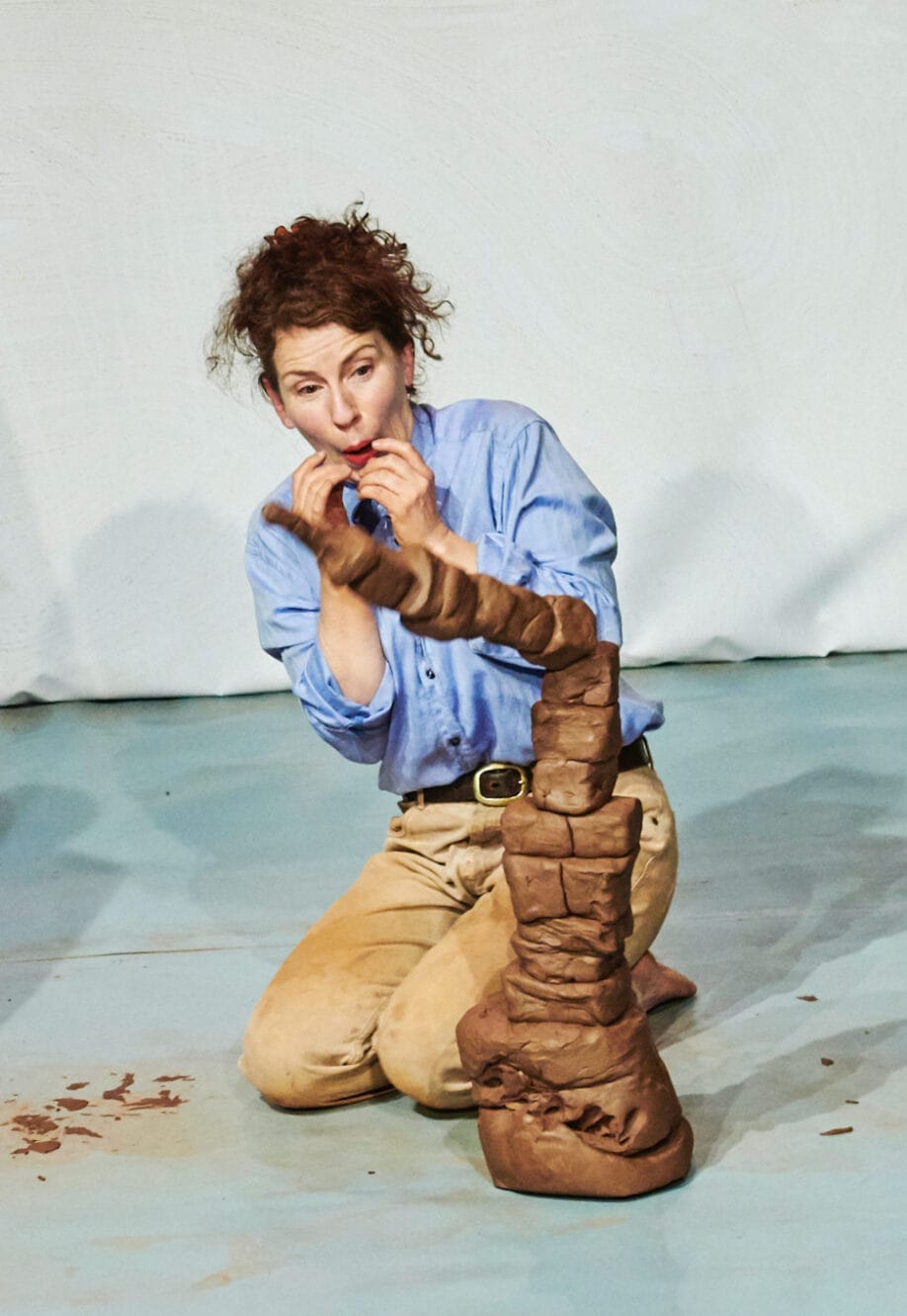 Claytime performer looks on nervously as a huge clay tower topples over!
