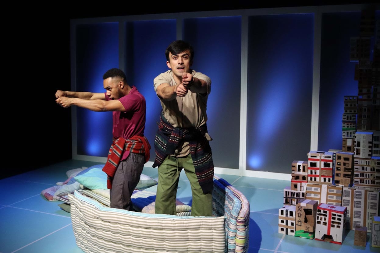 The two male characters are on a look out in their boat made out of mattresses.