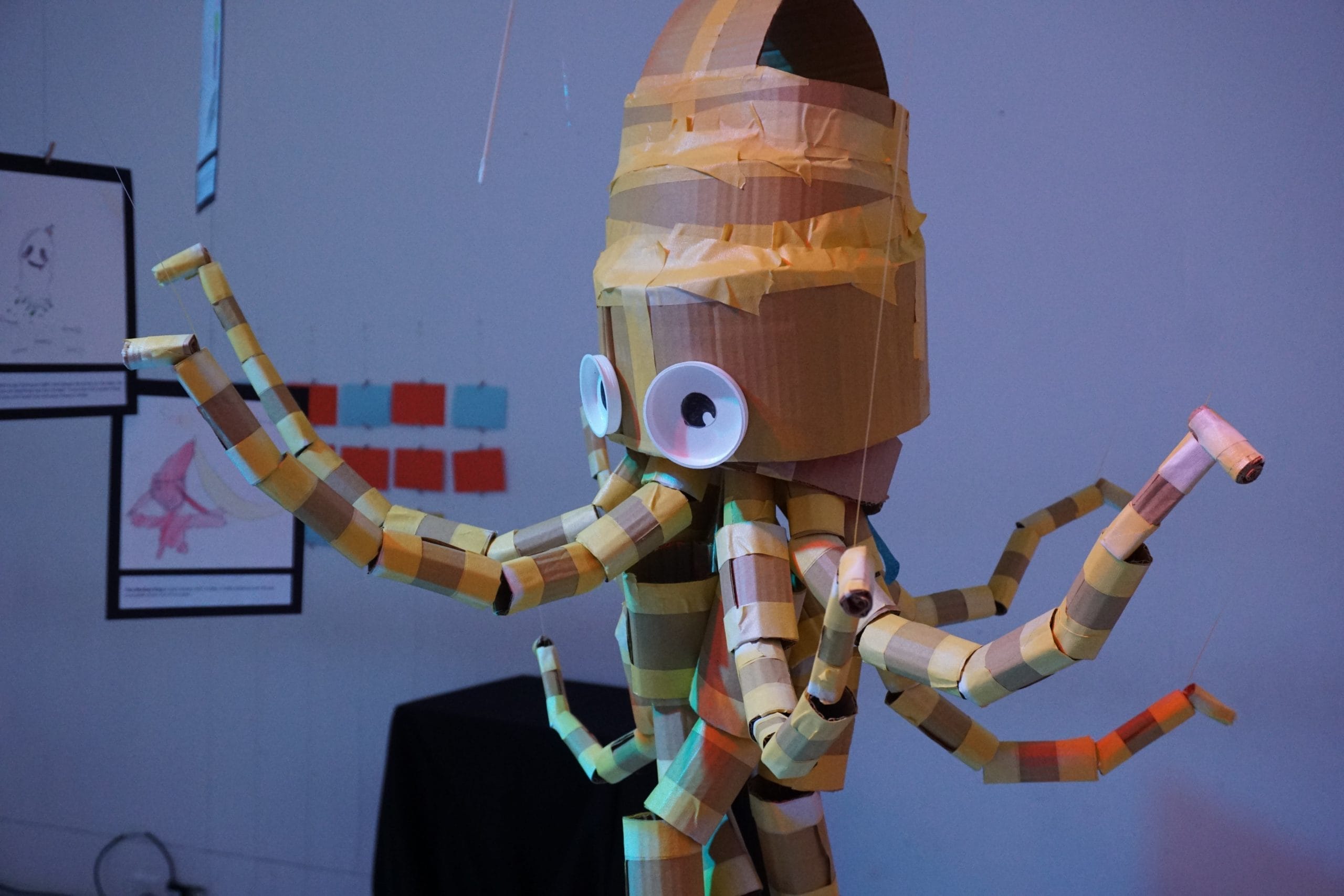 Close up shot of a hand-crafted cardboard octopus, constructed with sticky tape and other sustainable materials.