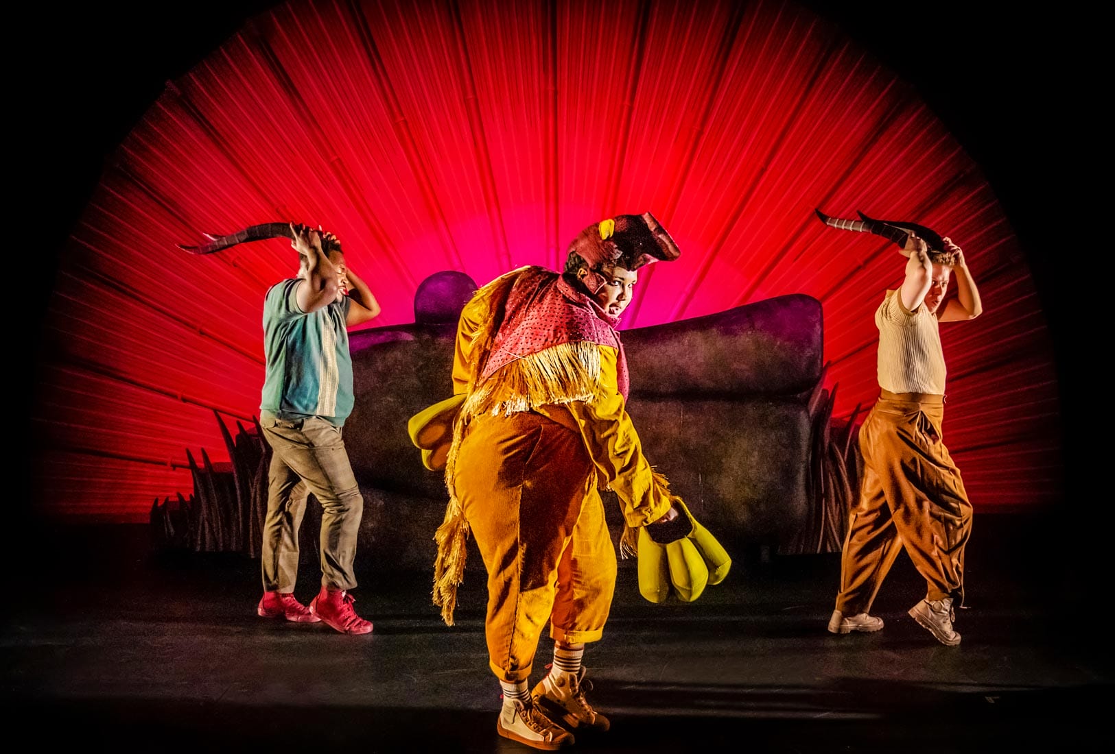 All characters doing a dance facing the audience against a red background.