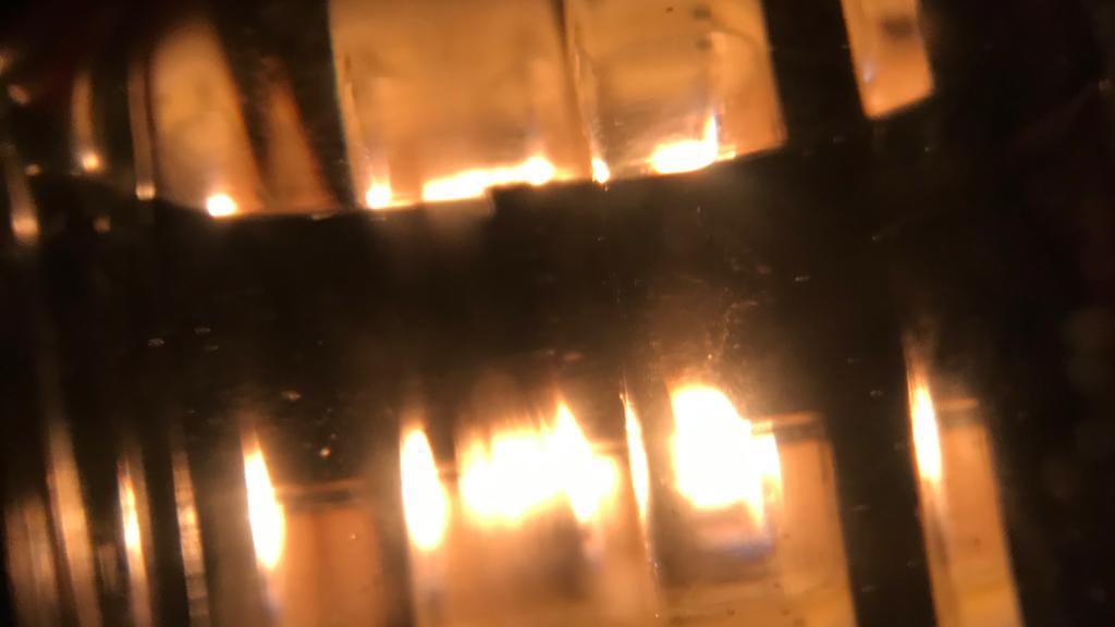 A distorted image showing warm golden glowing lights