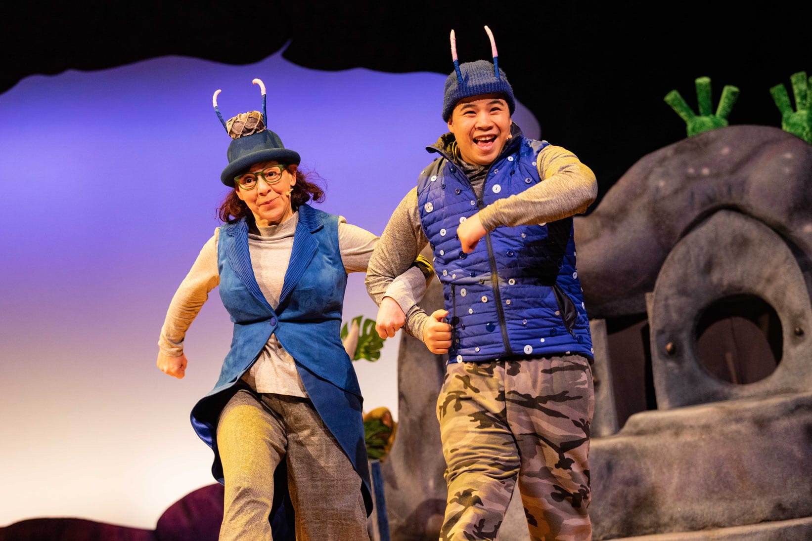 The Smoos are skipping about in their blue jackets and hat.
