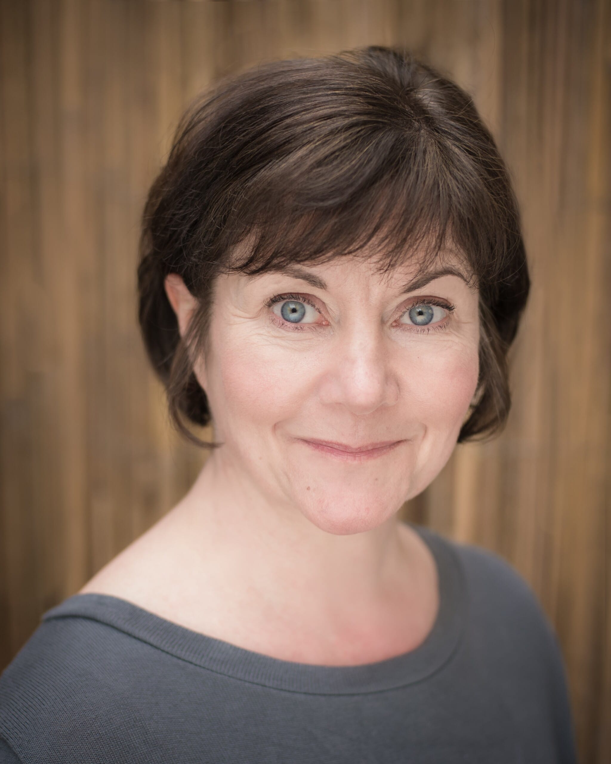 Head shot of Connie Walker. A white woman with short brown hair in a grey shirt.