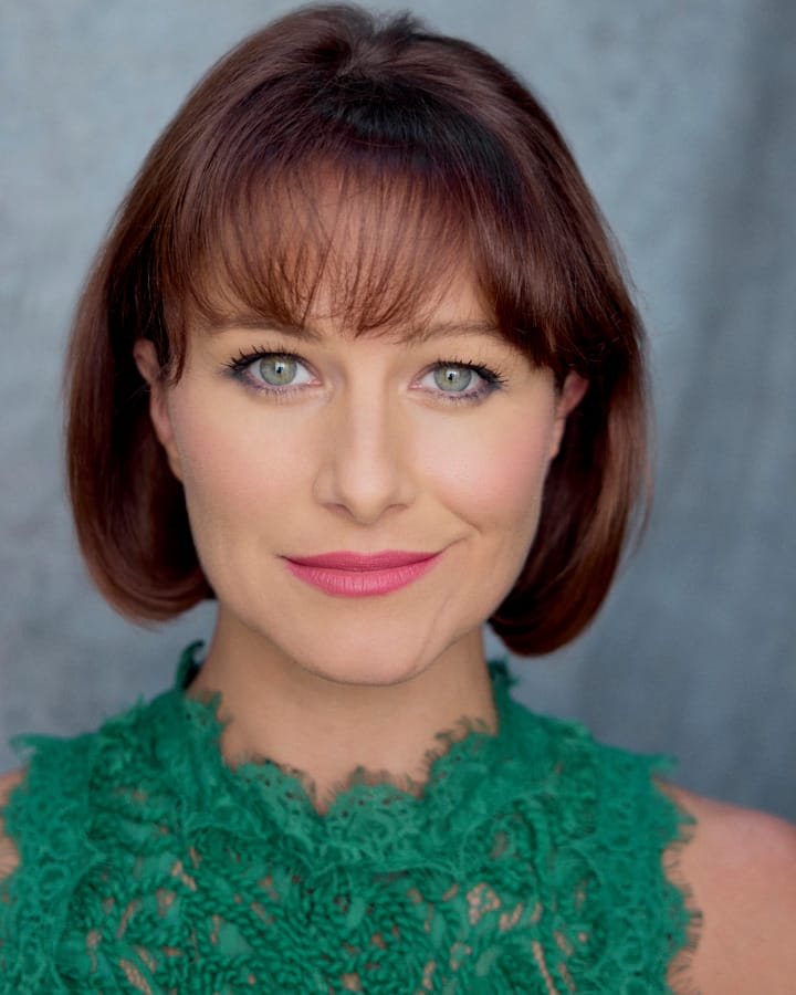 Head shot of Holly Smith. A white woman with short brown hair and blue eyes.
