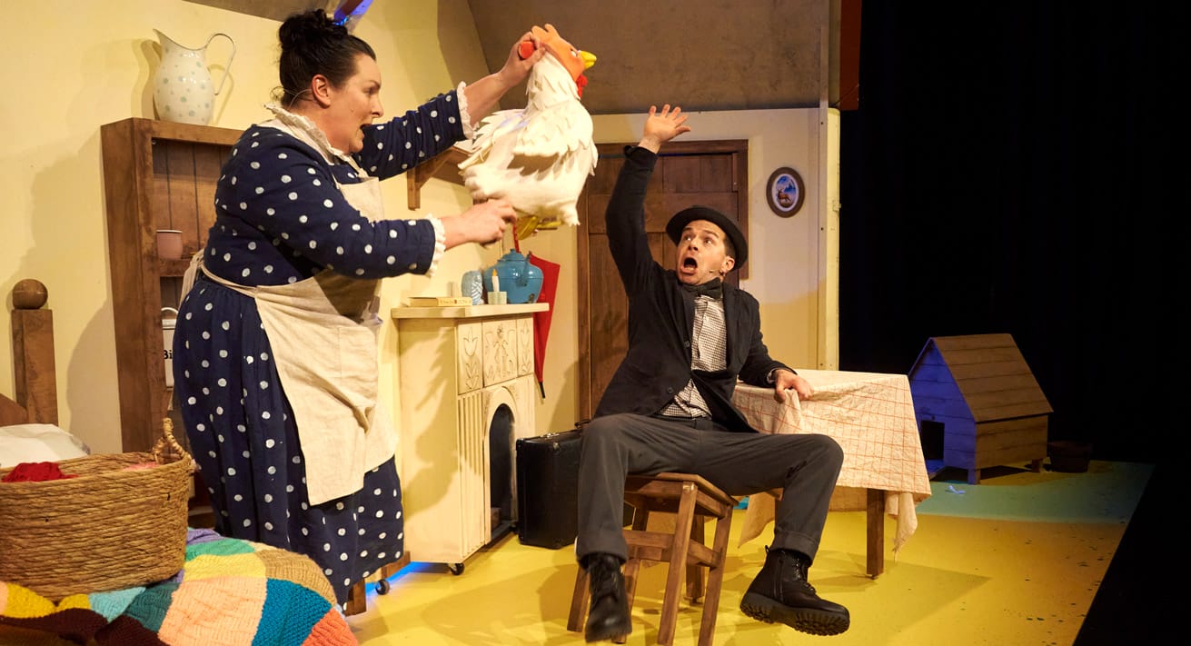A brightly lit production shot from the stage production of