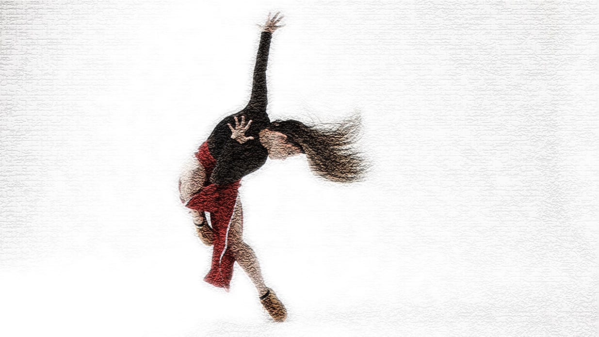 A blurred image of a dancer in a dynamic pose with one hand stretched upwards and one on their chest.